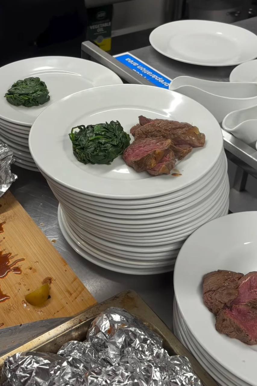 Plated beef and greens during service