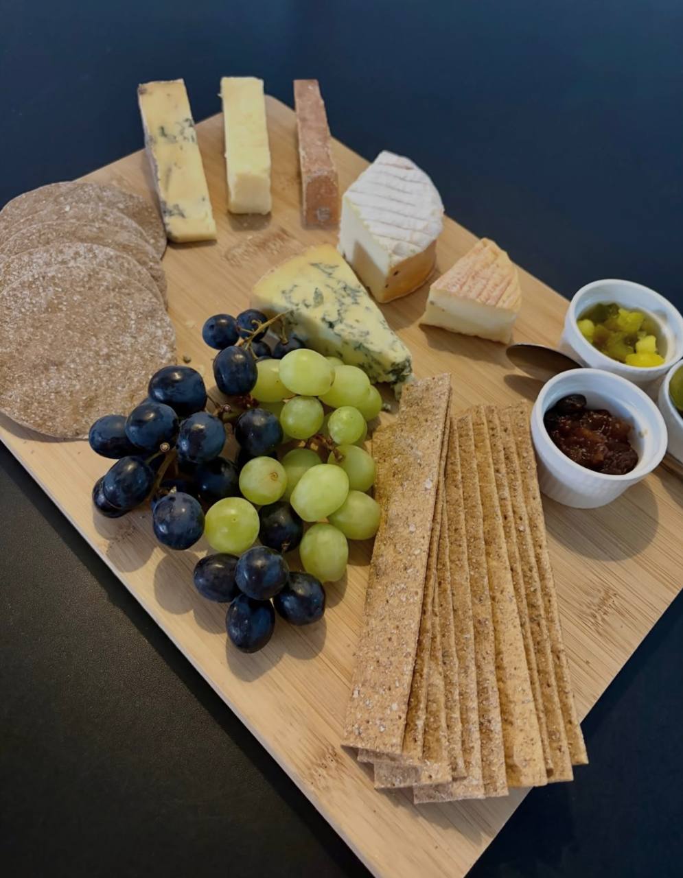 British cheese board with grapes and chutneys